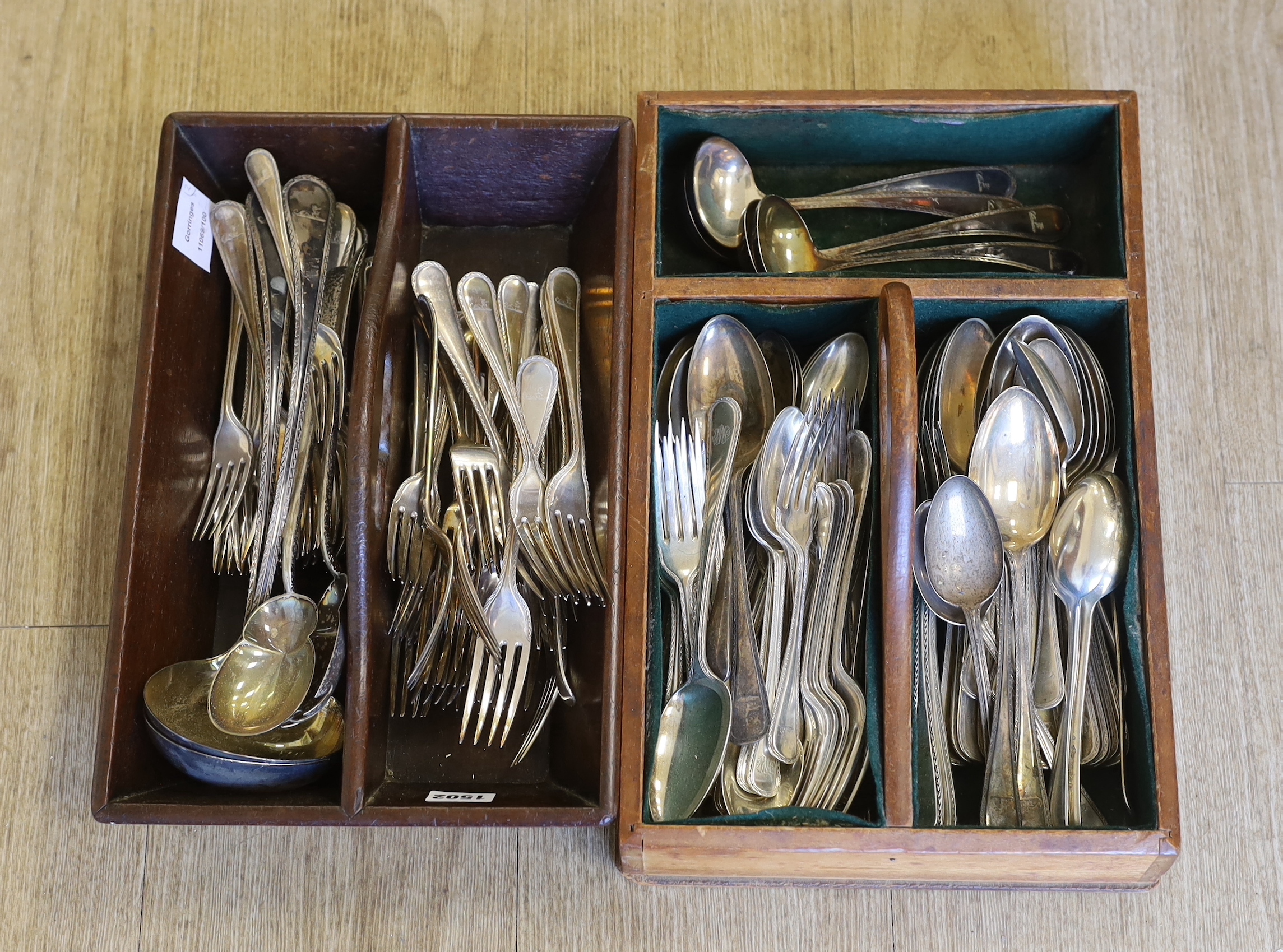 An Elkington & Co. plated canteen of cutlery, each piece engraved with a greyhound crest and two mahogany cutlery boxes